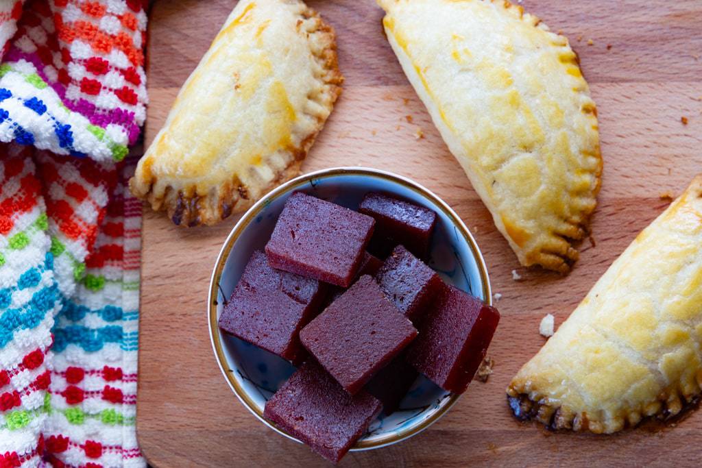 brushing a little bit of melted guava jelly over the top of each hot empanada