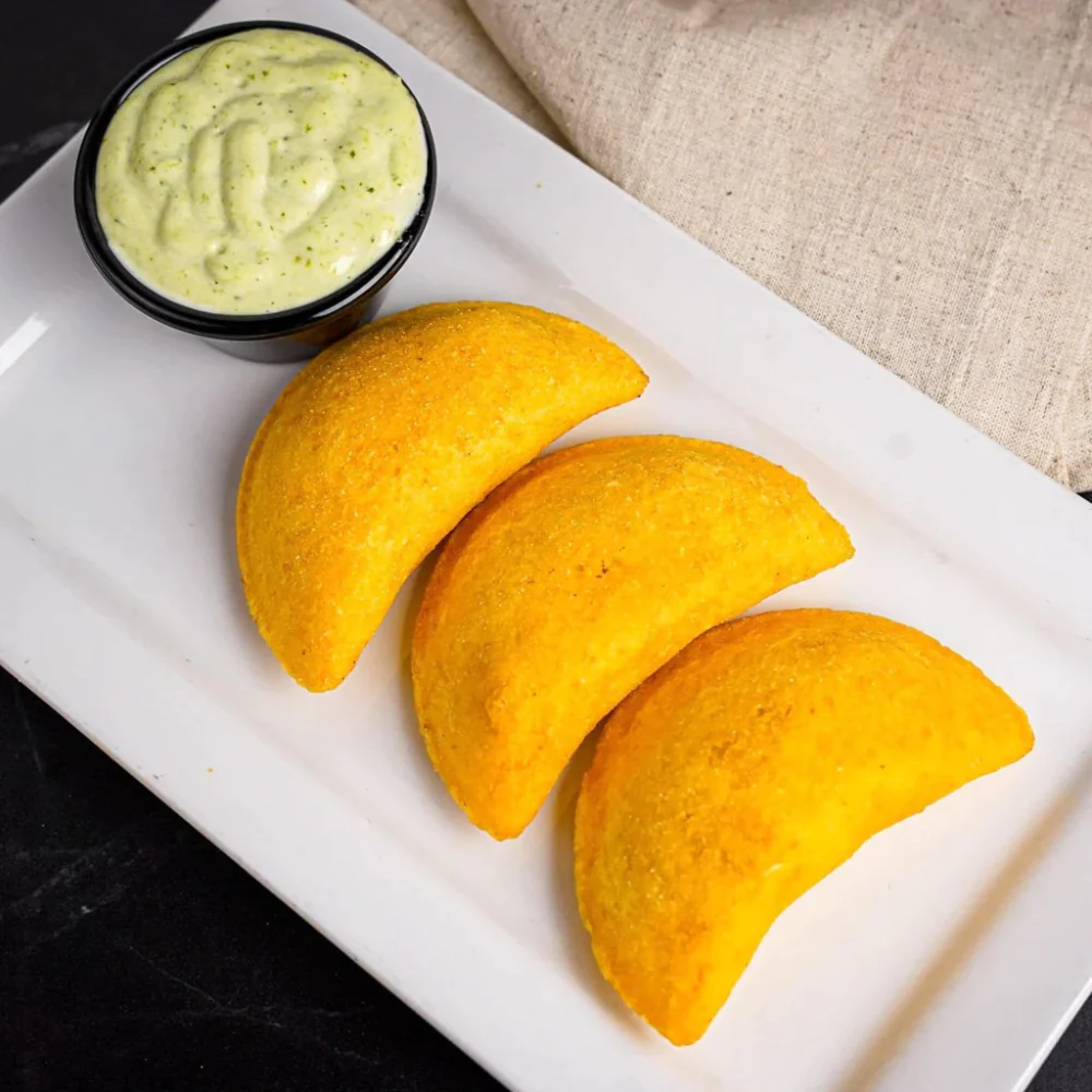 Colombian empanadas are typically served with a side of aji sauce for dipping 