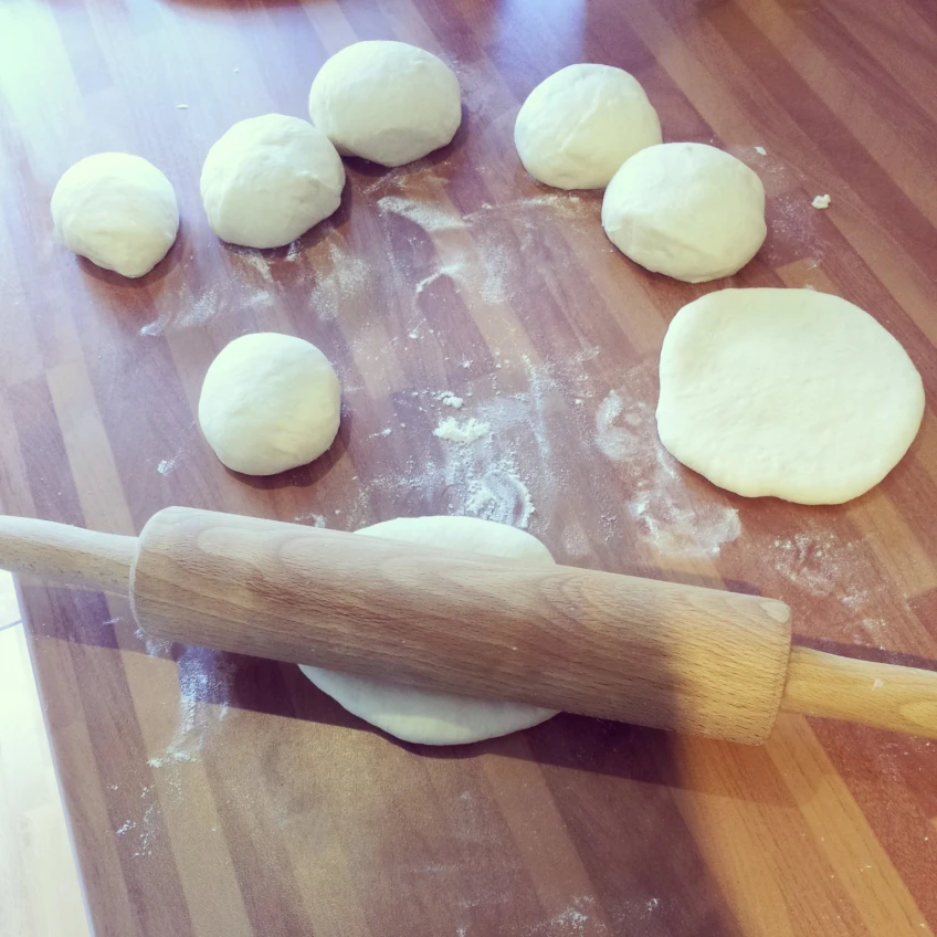  Take a small portion of Yuca dough, roll it into a ball, and then flatten it into a circle