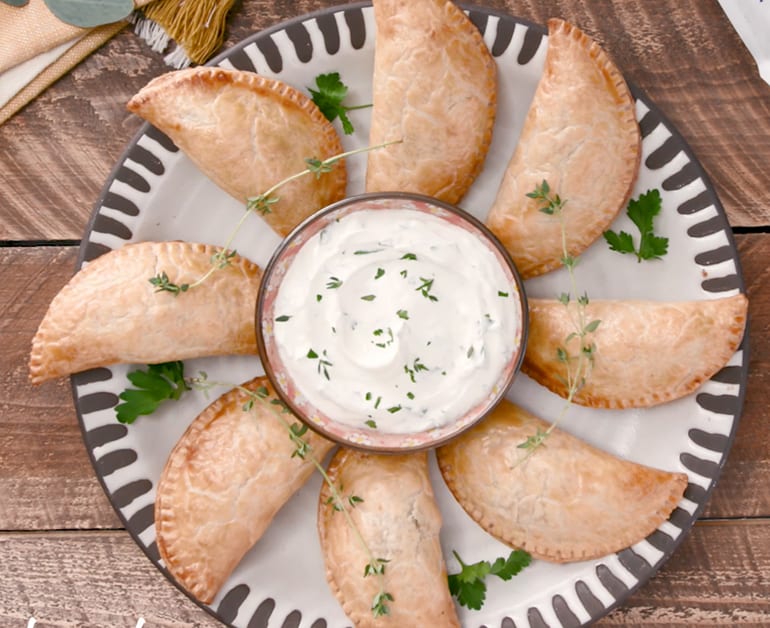 Serving  empanadas with sour cream